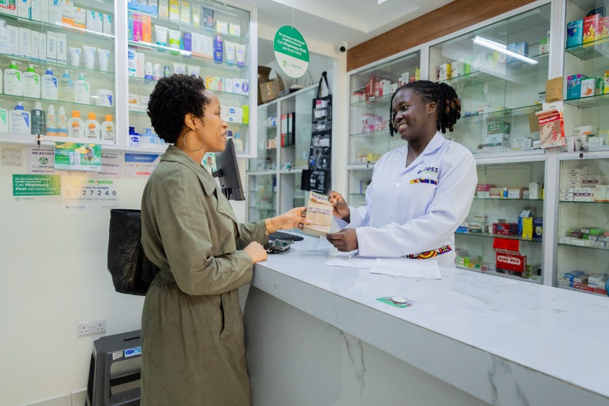 An Axcess pharmacist helping a customer at the pharmacy counter